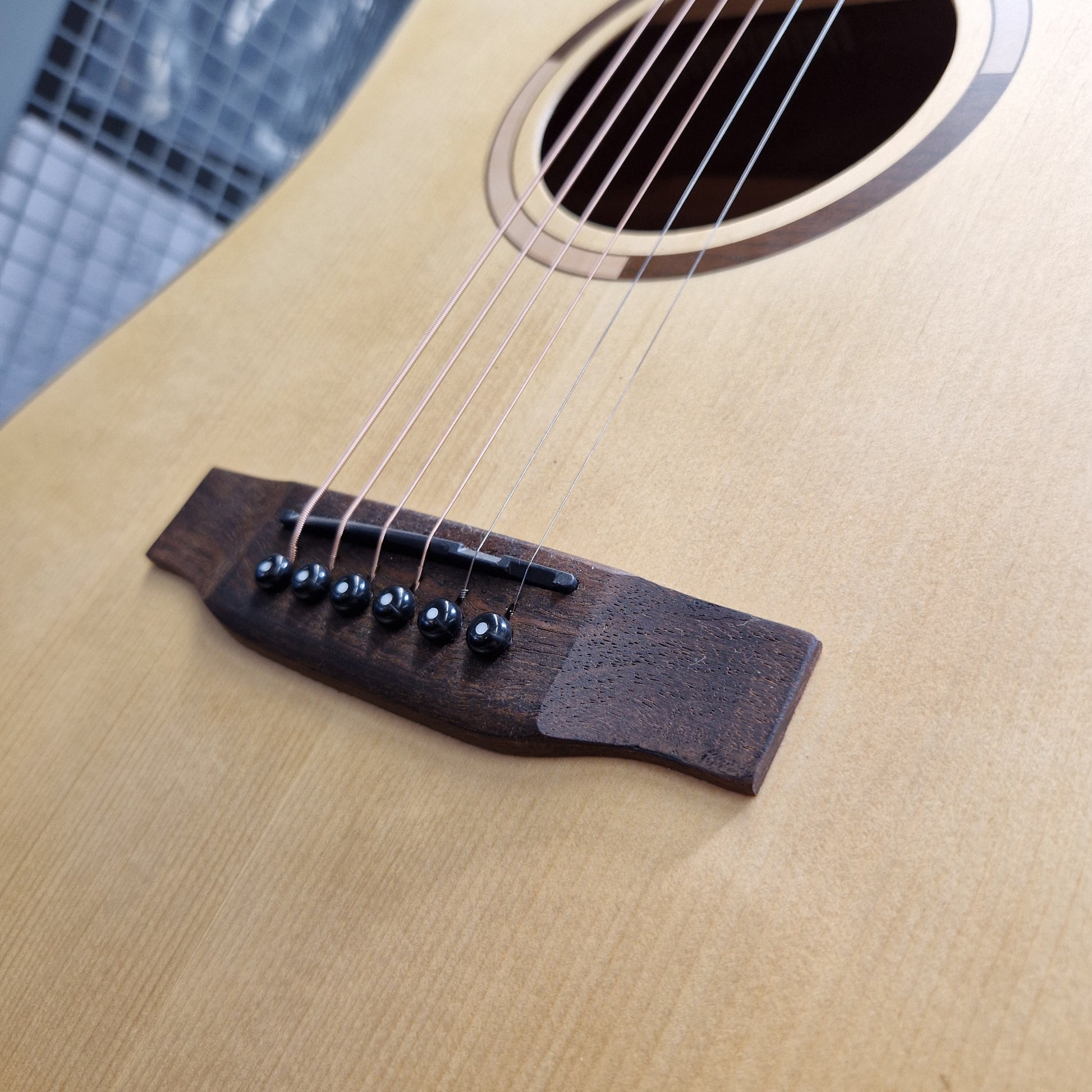 Pre-Owned Tanglewood TS5 Close-up of an acoustic guitar's soundhole and bridge