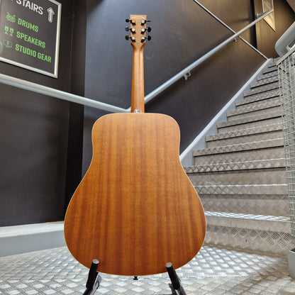 Pre-Owned Tanglewood TS5 Wooden acoustic guitar leaning against a wall with a staircase in the background