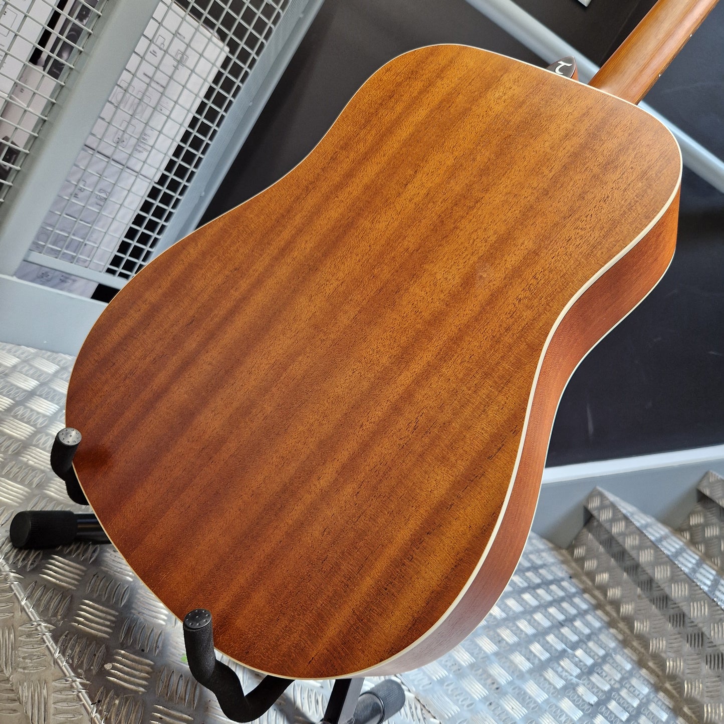 Pre-Owned Tanglewood TS5 Wooden guitar body on a stand with a cityscape background