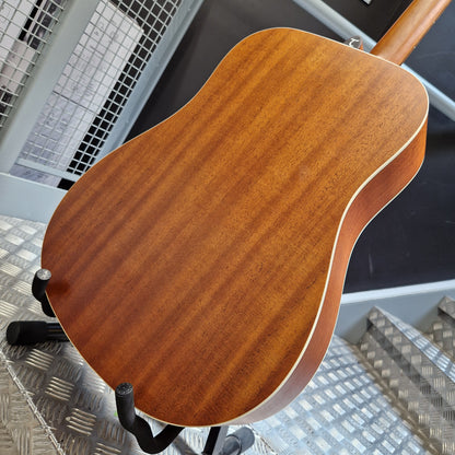 Pre-Owned Tanglewood TS5 Wooden guitar body on a stand with a cityscape background