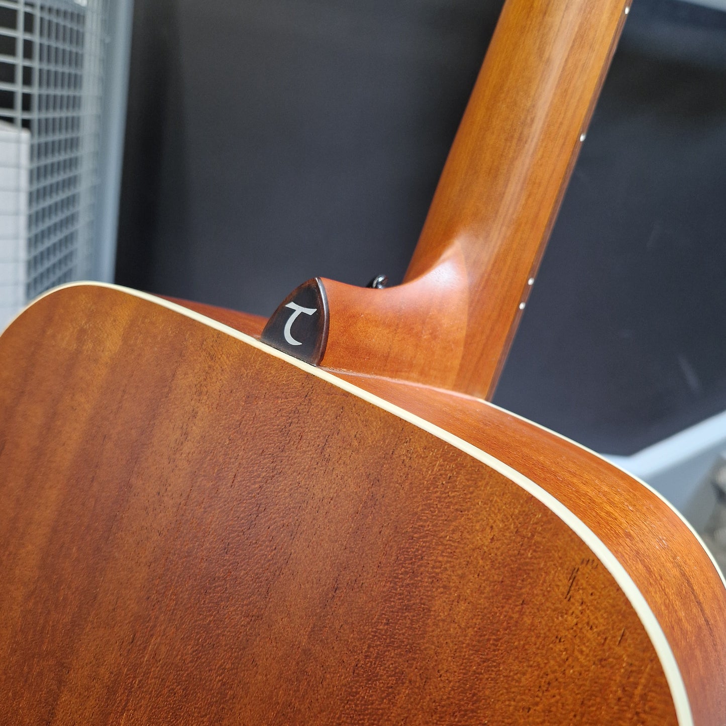 Pre-Owned Tanglewood TS5 Close-up of a wooden acoustic guitar with a blurred background