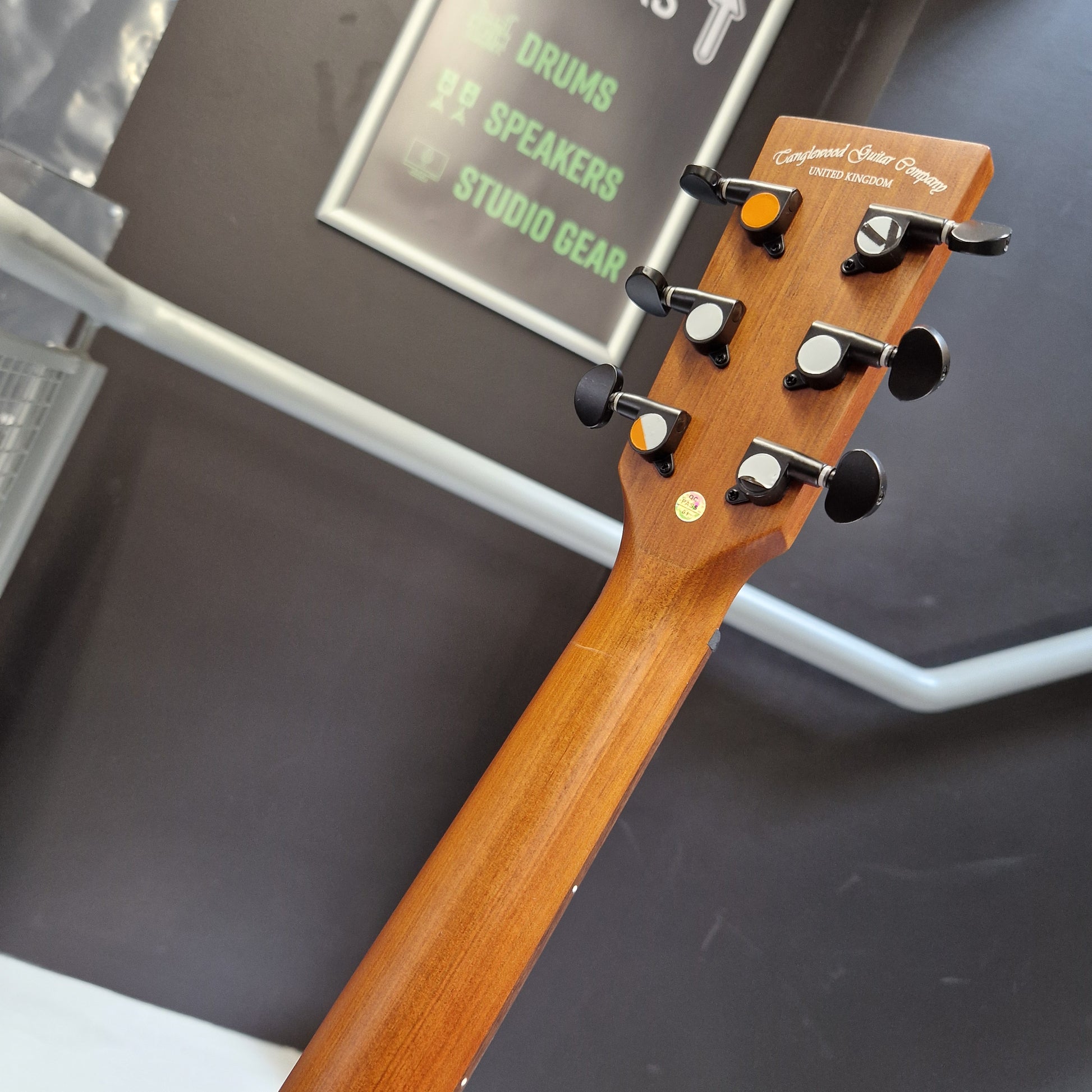 Pre-Owned Tanglewood TS5 Close-up of a guitar headstock with tuning pegs against a blurred background