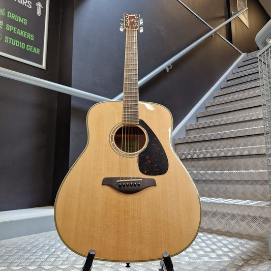 Pre-Owned Yamaha FG840 Acoustic guitar leaning against a wall with soundproofing panels