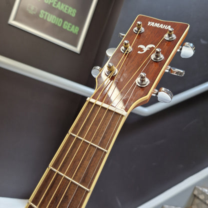 Pre-Owned Yamaha FG840 Yamaha guitar headstock with tuning pegs on a blurred background
