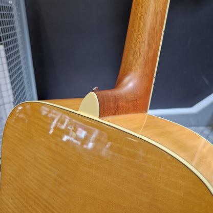 Pre-Owned Yamaha FG840 Close-up of a wooden guitar with a dark background