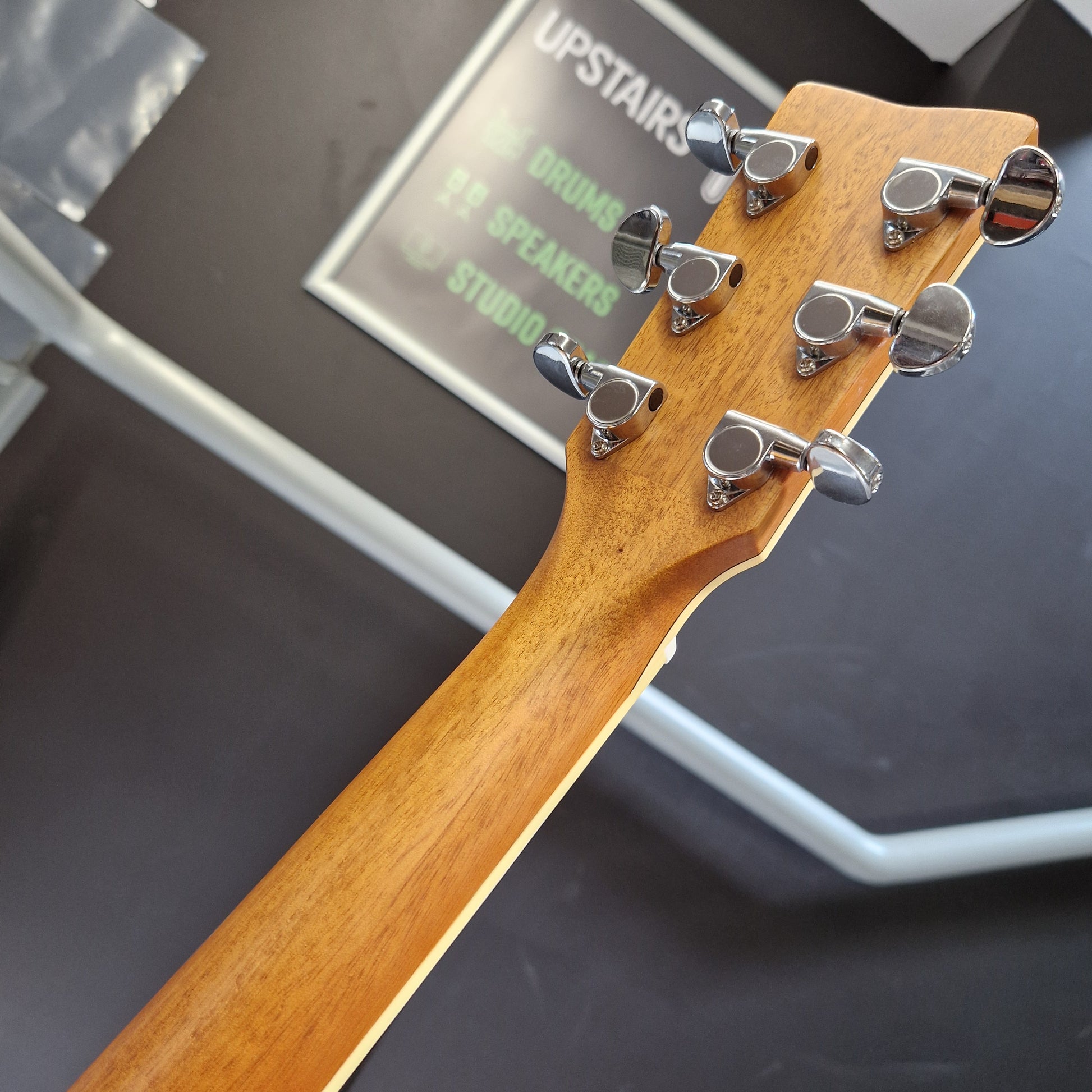 Pre-Owned Yamaha FG840 Close-up of a guitar headstock with tuning pegs on a blurred background