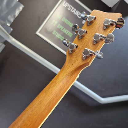 Pre-Owned Yamaha FG840 Close-up of a guitar headstock with tuning pegs on a blurred background