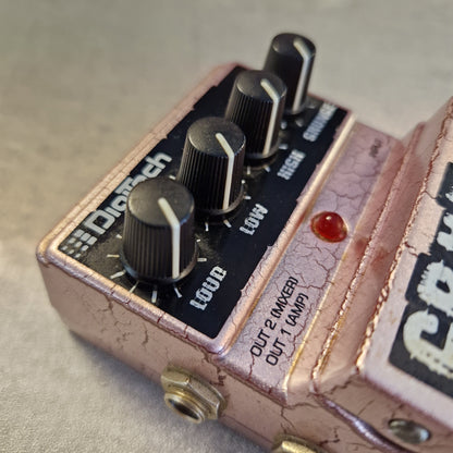 Pre-Owned Digitech Grunge A close-up of a Diaphy distortion guitar pedal with a distressed rose gold finish, black knobs, and a red indicator light.