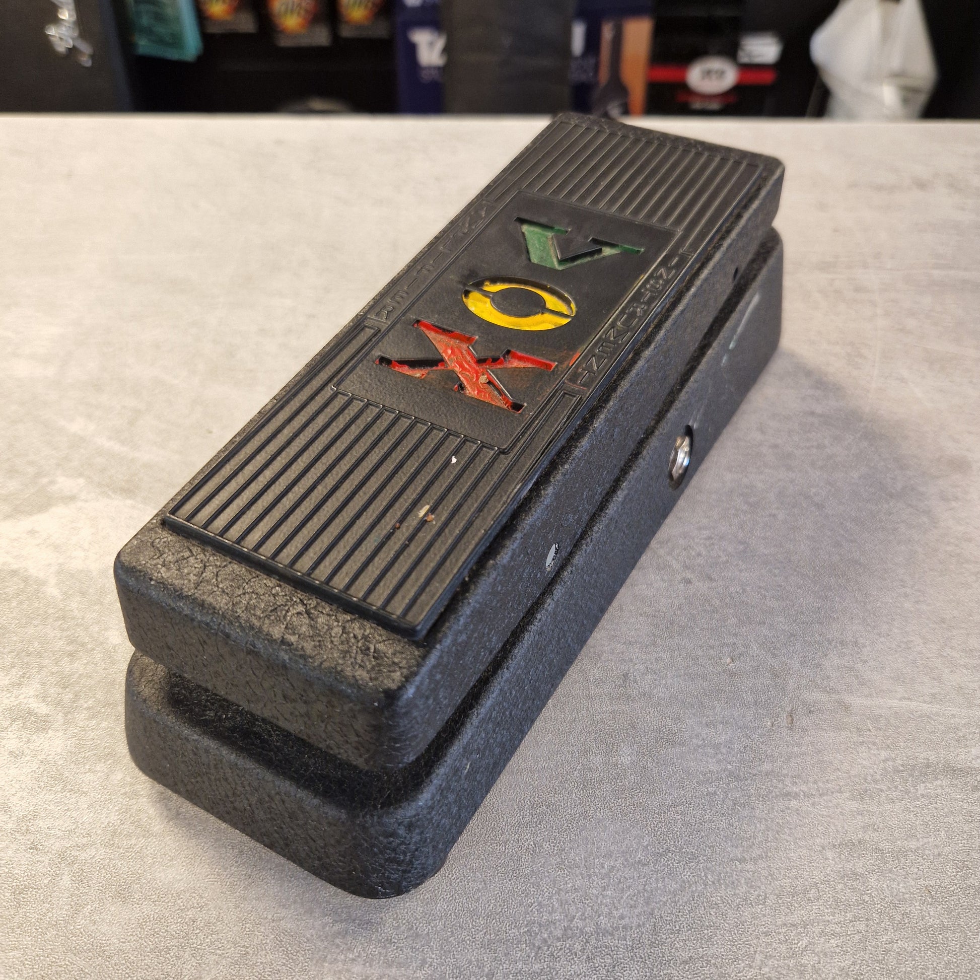 Pre-Owned Vox V845 A black textured plastic electronic control box with colorful triangular symbols (green, yellow, red) on the front, photographed on a gray concrete floor.