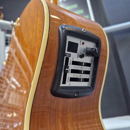 Pre-Owned Yamaha CPX700 Close-up of the back of a wooden electric guitar showing the control panel with volume, tune, low, mid, and high volume sliders.