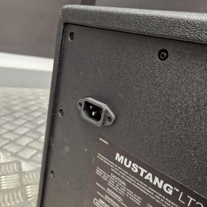 Pre-Owned Fender Close-up of the rear lower corner of a black Mustang LT200 amplifier, showing a power input socket and part of the product label.