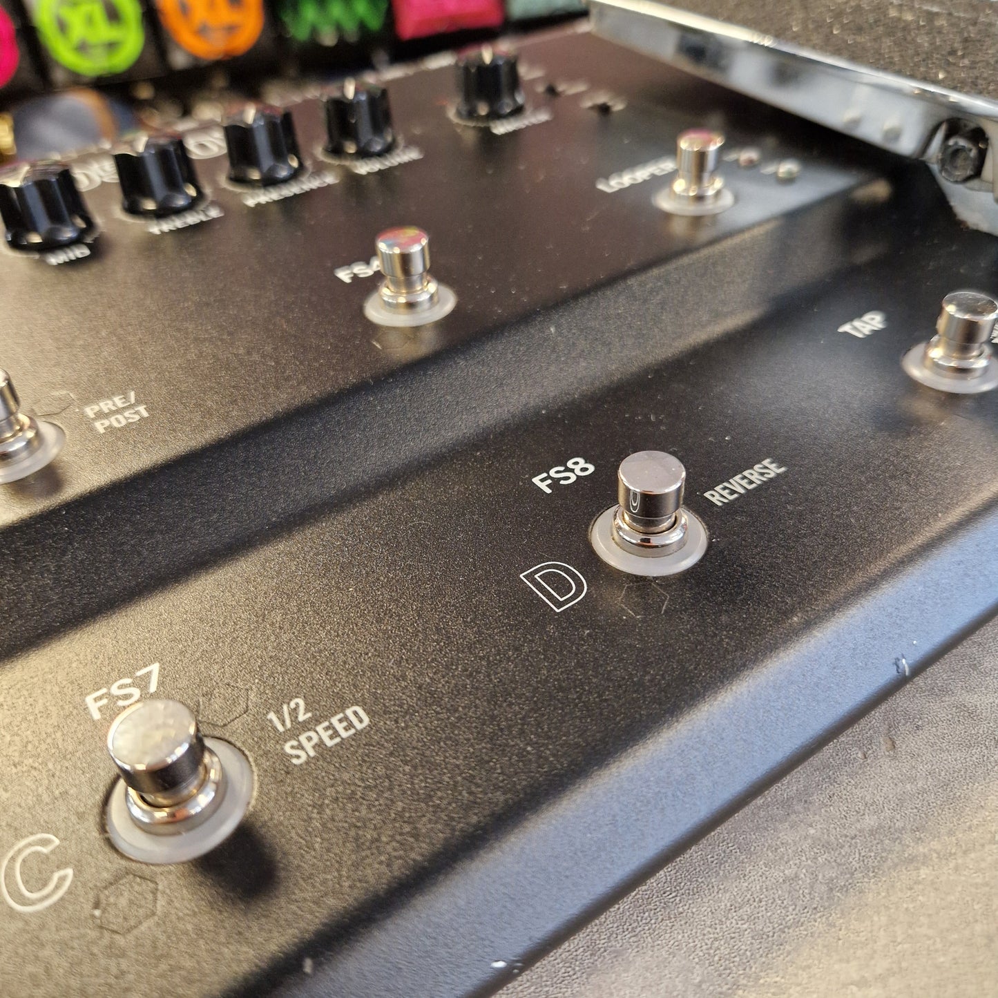 Pre-Owned Line 6 Close-up of a black metal electronic control panel with rotary switches, knobs, and white printed labels including 'FS8', 'D', '1/2 SPEED', and 'TAP'.