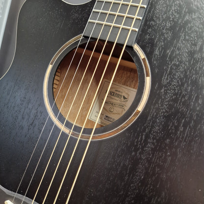 Pre-Owned Tanglewood TWBBSFCELH Close-up of a black acoustic guitar body with a visible sound hole, gold-toned strings, and a wood interior label.