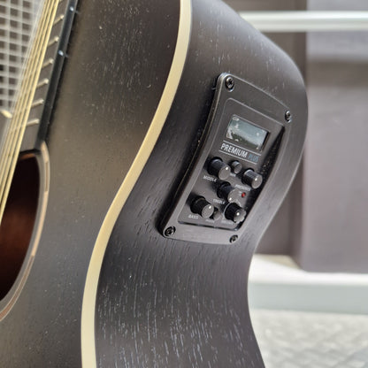 Pre-Owned Tanglewood TWBBSFCELH Close-up of a black electric guitar body showing the Pyle Micro control panel mounted on the side, with a cream-colored binding strip and part of the soundhole visible.