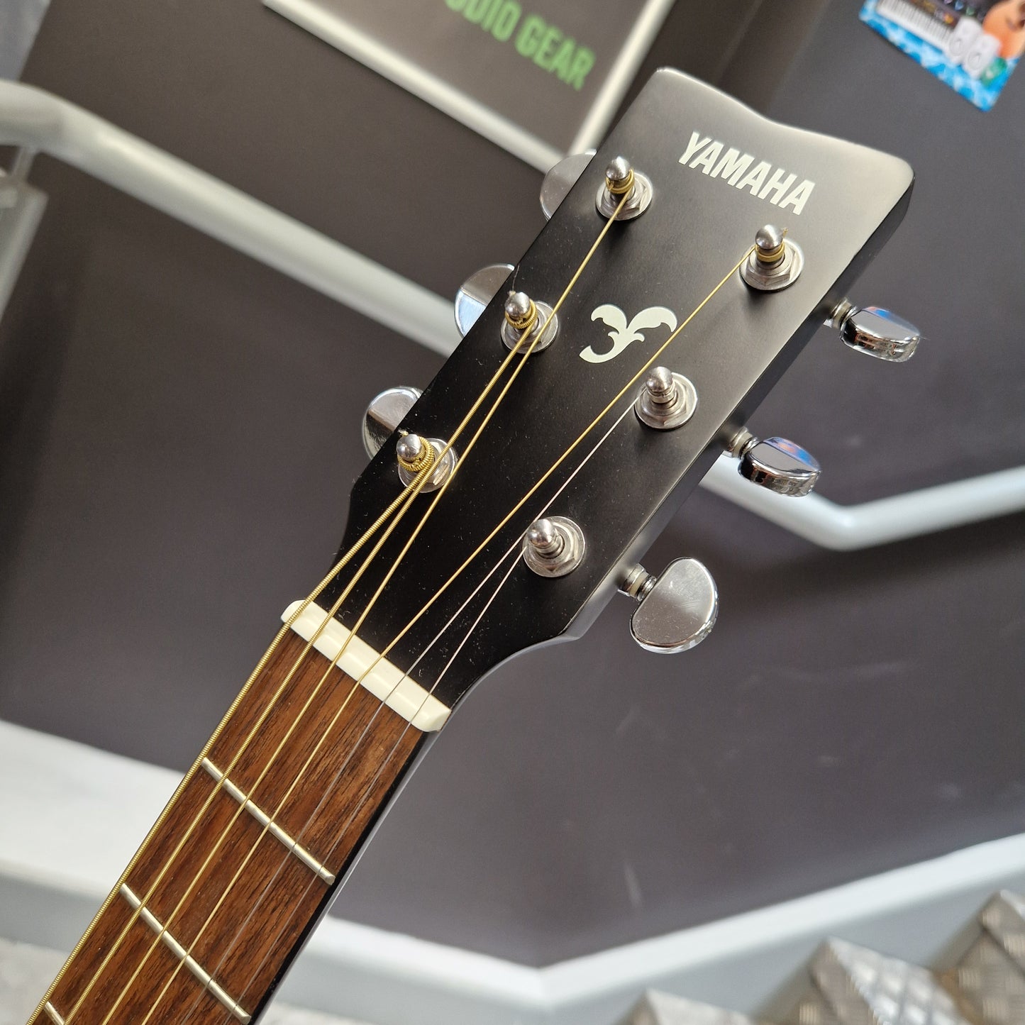 Pre-Owned Yamaha FG800 Close-up of a Yamaha acoustic guitar headstock and part of the fretboard, showing the brand name, tuning pegs, and wood tone.