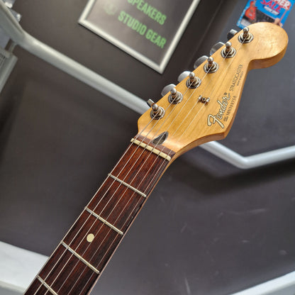 Pre-Owned Fender Mexican Stratocaster 1993 Electric - Lake Placid Blue Close-up of a Fender Stratocaster electric guitar headstock and upper fretboard, showing the natural wood finish, six silver tuning pegs, and dark brown fretboard against a dark display background.