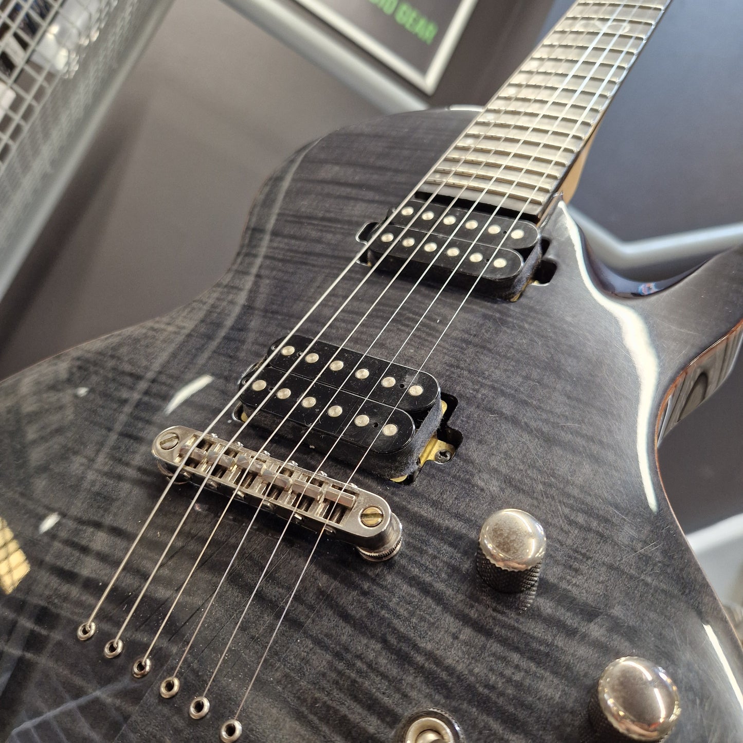 Pre-Owned Chapman ML-2 Electric - Grey Close-up of a black electric guitar body with a glossy flamed maple finish, chrome hardware, and black humbucker pickups.