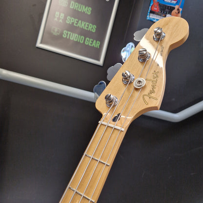 Pre-Owned Fender Player Precision Bass - Limited Edition Electron Green Close-up of a Fender bass guitar headstock and neck, showing the natural wood finish, four tuning pegs, and four strings against a dark display background.