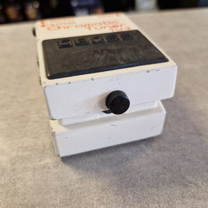 Pre-Owned Boss TU-3 Tuner Pedal A white guitar effects pedal with a black control knob and a black label panel, photographed at an angle on a gray textured surface.