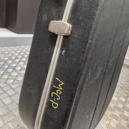 Pre-Owned Hiscox LiteFlite Acoustic Hard Case A close-up of a black textured hard case with a silver metal latch and a yellow handwritten marking reading 'MCP'.