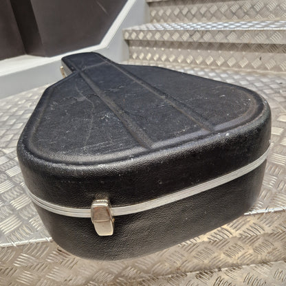 Pre-Owned Hiscox LiteFlite Acoustic Hard Case A black hard guitar case with a silver metal zipper and latch, resting on a diamond plate metal staircase.