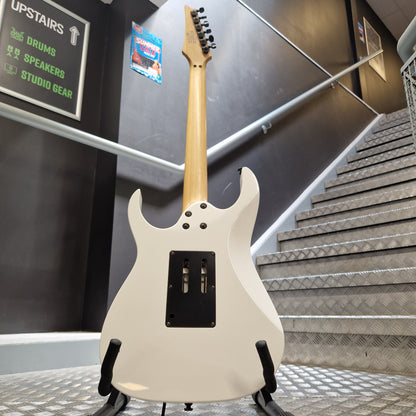 Pre-Owned Ibanez RG350DX Electric - White An electric guitar with a cream-colored body and a natural wood neck, displayed on a stand in a stairwell.