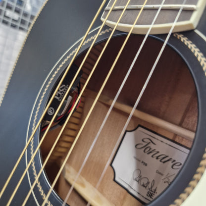 Pre-Owned PRS P20 Tonare Parlor Electro-Acoustic - Black Close-up detail of a Fonda acoustic guitar, showing the sound hole, gold-toned strings, rosette inlay, and interior wood grain with a Fonda label visible.