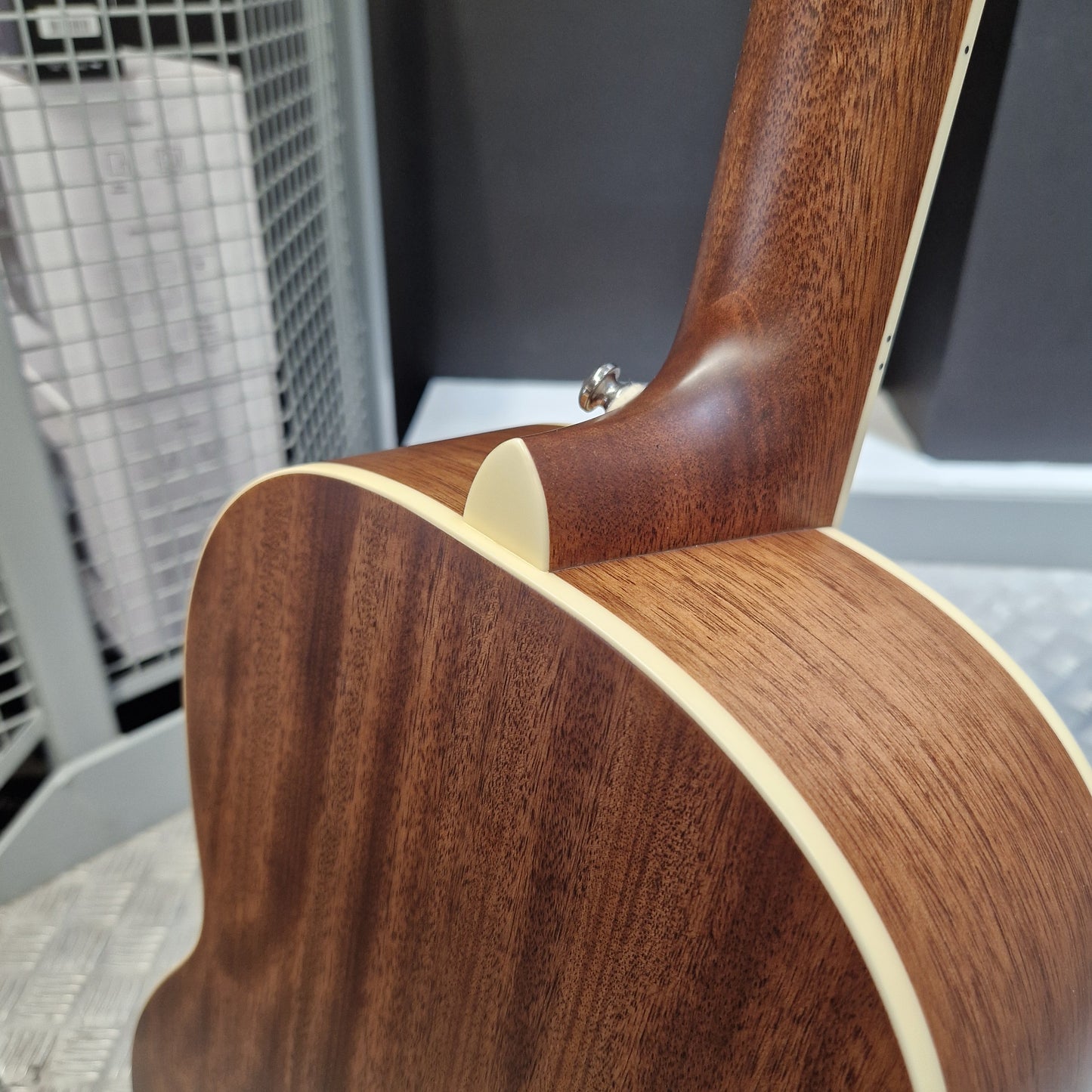Pre-Owned PRS P20 Tonare Parlor Electro-Acoustic - Black Close-up of the back of an acoustic guitar showing a rich dark brown wood grain finish and cream-colored binding.