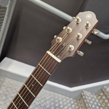 Pre-Owned Yamaha SLG200S Silent Guitar Electro-Acoustic - Natural Close-up of a Yamaha acoustic guitar headstock and neck, showing the brand logo, six tuning pegs, and six strings on a dark wood fretboard.