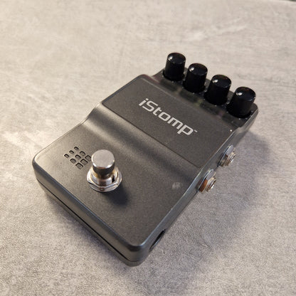 Pre-Owned DigiTech iStomp Switchable Multi Guitar Effects Pedal A black iStomp guitar effects pedal with four black control knobs and a silver footswitch, photographed on a textured gray surface.