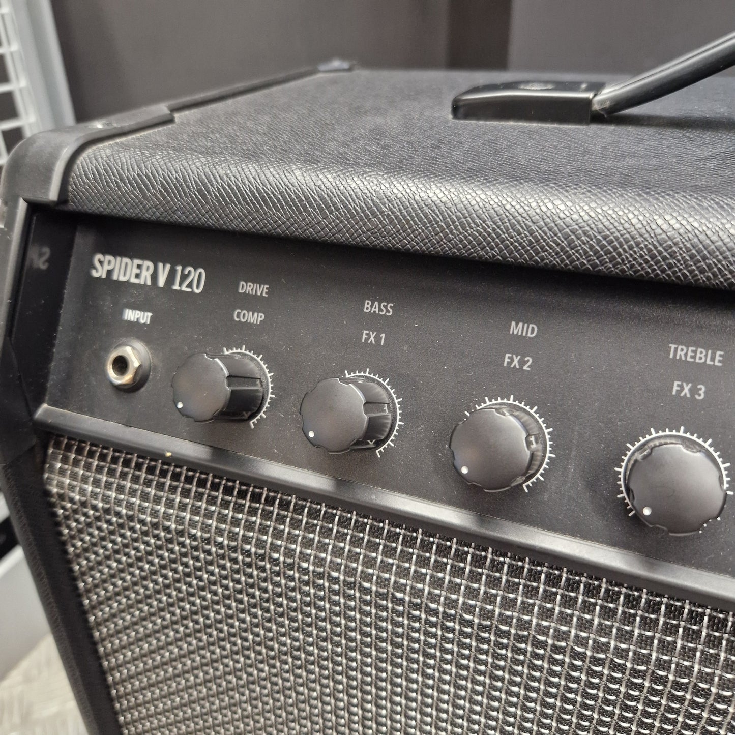 Pre-Owned Line 6 Spider V 120 Mk II Guitar Combo Amplifier Close-up of a black Spider V120 guitar amplifier showing the front control panel with knobs and speaker grille.