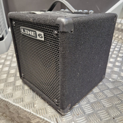Pre-Owned Line 6 LowDown Studio 110 75w Digital Bass Combo A used Line 6 mini guitar amplifier with a black textured cloth cover and metal grille, resting on a diamond plate metal surface.