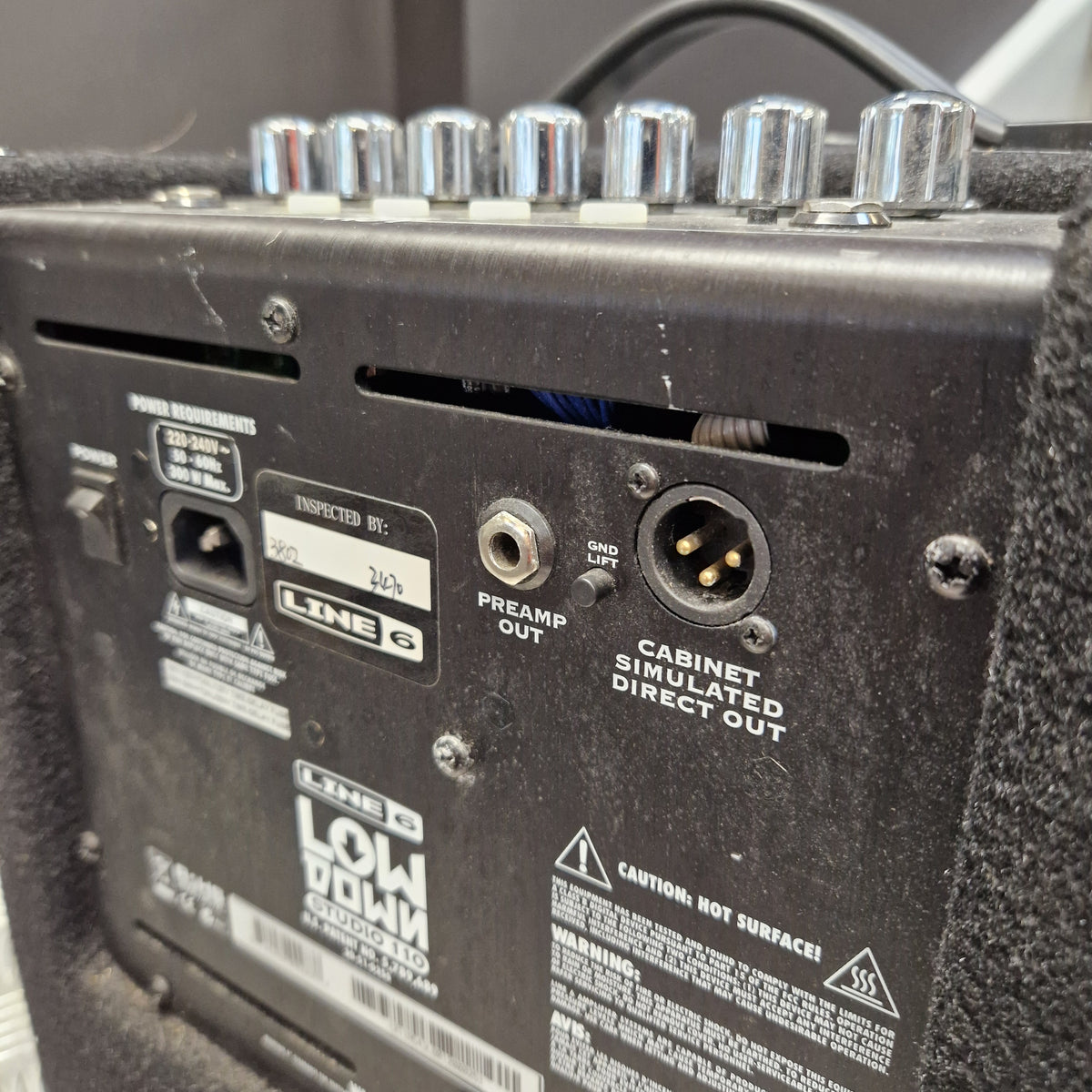 Pre-Owned Line 6 LowDown Studio 110 75w Digital Bass Combo Close-up of the rear panel of a black LINE 6 Low Down guitar amp, showing control knobs, input jack, preamp out, direct out, and warning labels.