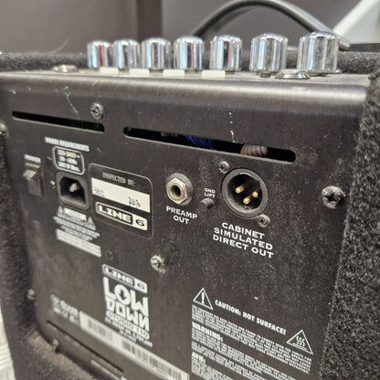 Pre-Owned Line 6 LowDown Studio 110 75w Digital Bass Combo Close-up of the rear panel of a black LINE 6 Low Down guitar amp, showing control knobs, input jack, preamp out, direct out, and warning labels.