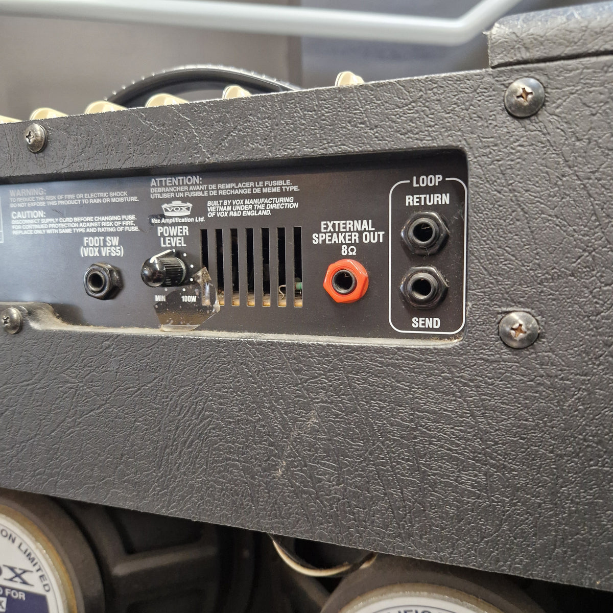 Pre-Owned Vox VT100 Valvetronix 100w Electric Combo Close-up of the rear input and output panel of a black textured guitar amplifier or speaker cabinet, showing jacks labeled LOOP RETURN, EXTERNAL SPEAKER OUT, SEND, and POWER LEVEL.