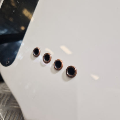 Pre-Owned Traben Neo 4 Bass - White Four small round metallic screw terminals with copper-colored rings on a glossy white guitar body, photographed close up.