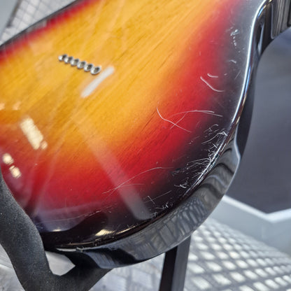 Pre-Owned Fender American Standard Telecaster 2000 Electric - 3-Colour Sunburst Close-up of the back of a sunburst electric guitar showing a glossy yellow-to-red gradient finish with visible scratches on the glossy surface.