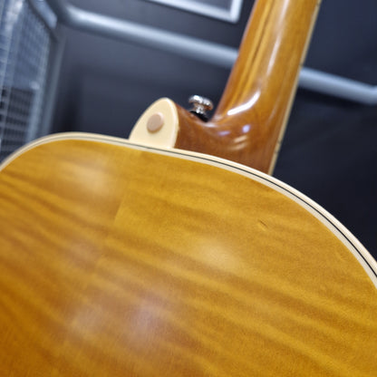 Pre-Owned Epiphone Masterbilt Zenith Classic Electro-Acoustic - Vintage Natural Close-up detail of an acoustic guitar's back, showing the glossy natural wood grain finish and the transition to the neck.