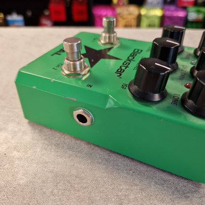 Pre-Owned Blackstar LT-DUAL Two-Channel Distortion Pedal A green Breezader vocal effect pedal with black and silver knobs, shown close-up on a gray textured surface with a blurred background.