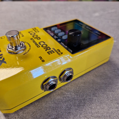 Pre-Owned Nux Loop Core Stereo Looper Pedal A close-up shot of a yellow Boss Loop Core Stereo guitar effects pedal on a gray textured surface.