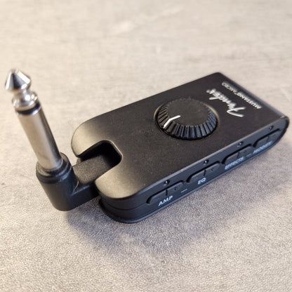 Pre-Owned Fender Mustang Micro Headphone Guitar Amplifier A black Fender Wah-Wah2 wireless guitar effects pedal with a 1/4-inch jack connector, resting on a textured gray surface.