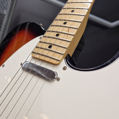 Pre-Owned Fender Player Telecaster 2022 Electric - 3-Colour Sunburst Close-up of an electric guitar showing the white body, sunburst edge, chrome hardware, and natural wood fretboard.