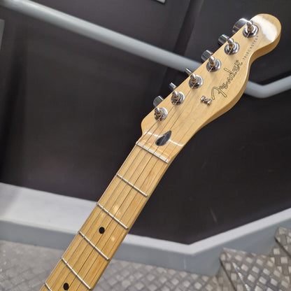 Pre-Owned Fender Player Telecaster 2022 Electric - 3-Colour Sunburst Close-up of a Fender electric guitar headstock and upper neck, showing a light natural wood finish, chrome tuning pegs, and the Fender logo against a dark gray background.