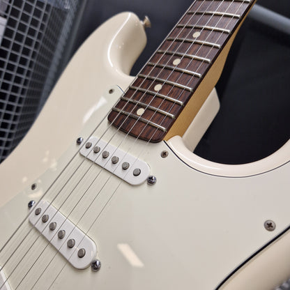 Pre-Owned Fender Standard Strocaster 2014 Electric - Arctic White Close-up of an electric guitar body in cream with a dark brown fretboard and silver hardware, photographed against a dark background.