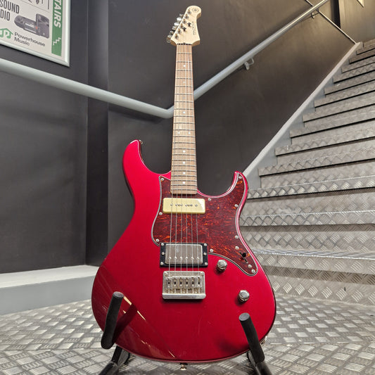 Pre-Owned Yamaha Pacifica 311H Electric - Red Metallic A red electric guitar with a maple neck and headstock, displayed on a stand in front of a staircase.