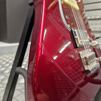 Pre-Owned Yamaha Pacifica 311H Electric - Red Metallic Close-up of a glossy red electric guitar body with chrome hardware and a black stand in the background.
