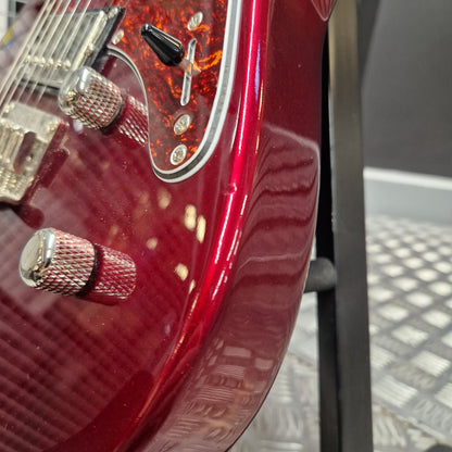 Pre-Owned Yamaha Pacifica 311H Electric - Red Metallic Close-up of a glossy red electric guitar body with chrome hardware, a black pickup, and a textured pickguard, photographed indoors against a dark and gray background.