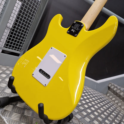 Pre-Owned PRS SE Silver Sky John Mayer Signature Electric - Dandy Lion A bright yellow electric guitar body on a stand, photographed in a workshop or studio setting with a metal grate background.