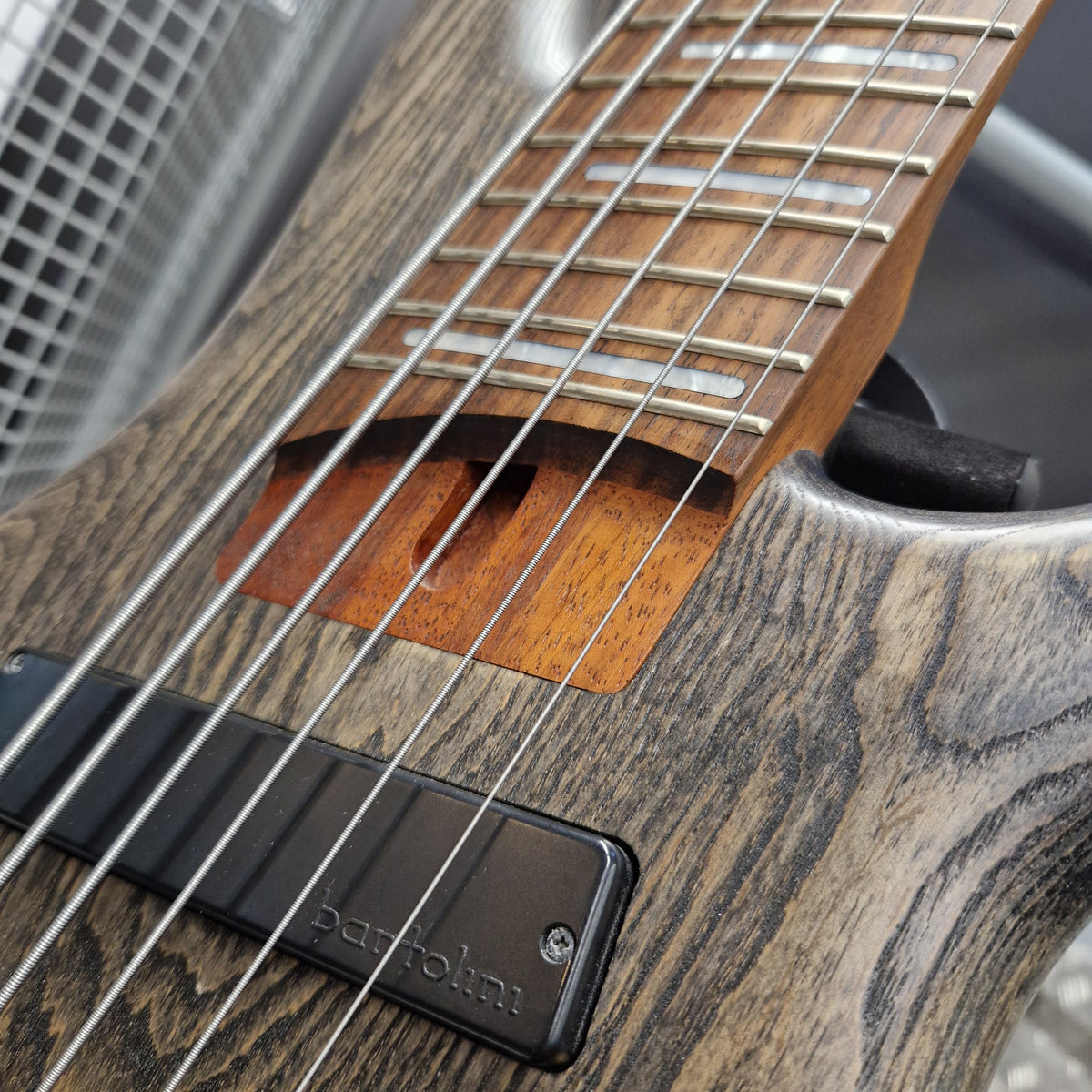 Pre-Owned Ibanez SRFF806 Multi-Scale 6-String Bass - Black Stained Close-up of a Barolin electric guitar showing the wood grain body, neck, strings, and a black pickup with the Barolin logo.