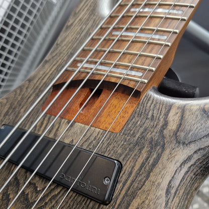 Pre-Owned Ibanez SRFF806 Multi-Scale 6-String Bass - Black Stained Close-up of a Barolin electric guitar showing the wood grain body, neck, strings, and a black pickup with the Barolin logo.